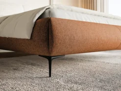 Łóżko tapicerowane 140x200 cm Ovalle z pojemnikiem stelaż metalowy miedziane plecionka hydrofobowa nóżki czarne