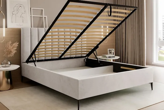 Łóżko tapicerowane 140x200 cm Veloro z pojemnikiem beżowe welur stelaż metalowy na wysokich nóżkach